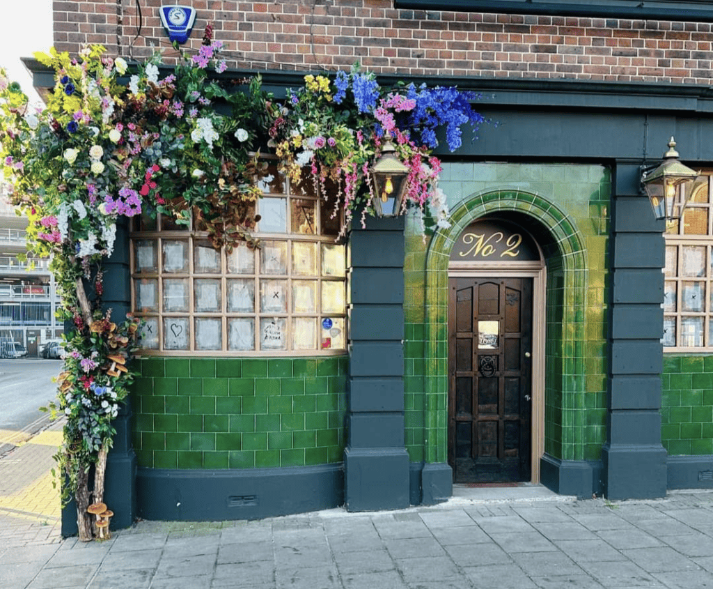 The old curiosity cafe Bedford outside flowers
